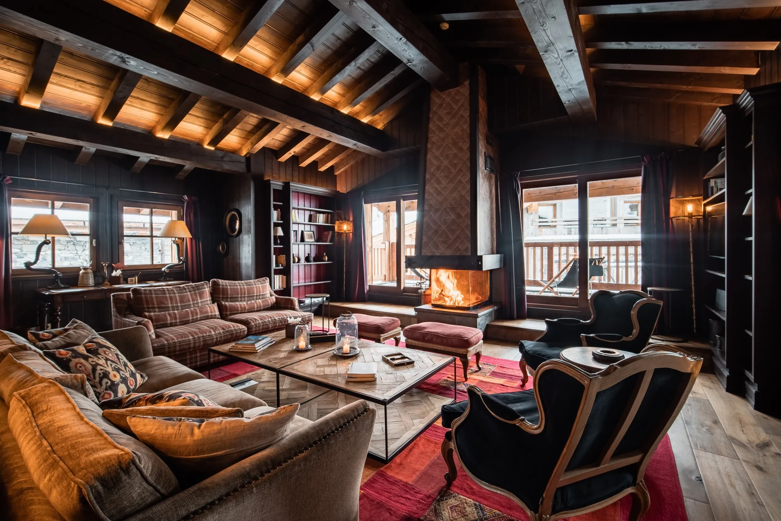 Salon chalet avec cheminée et canapés confortables, à Val d’Isère, Hôtel Village La Mourra.
